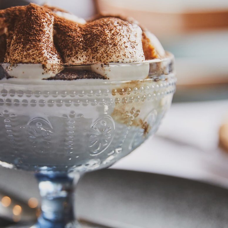 Tiramisu dusted with cocoa in a glass dish