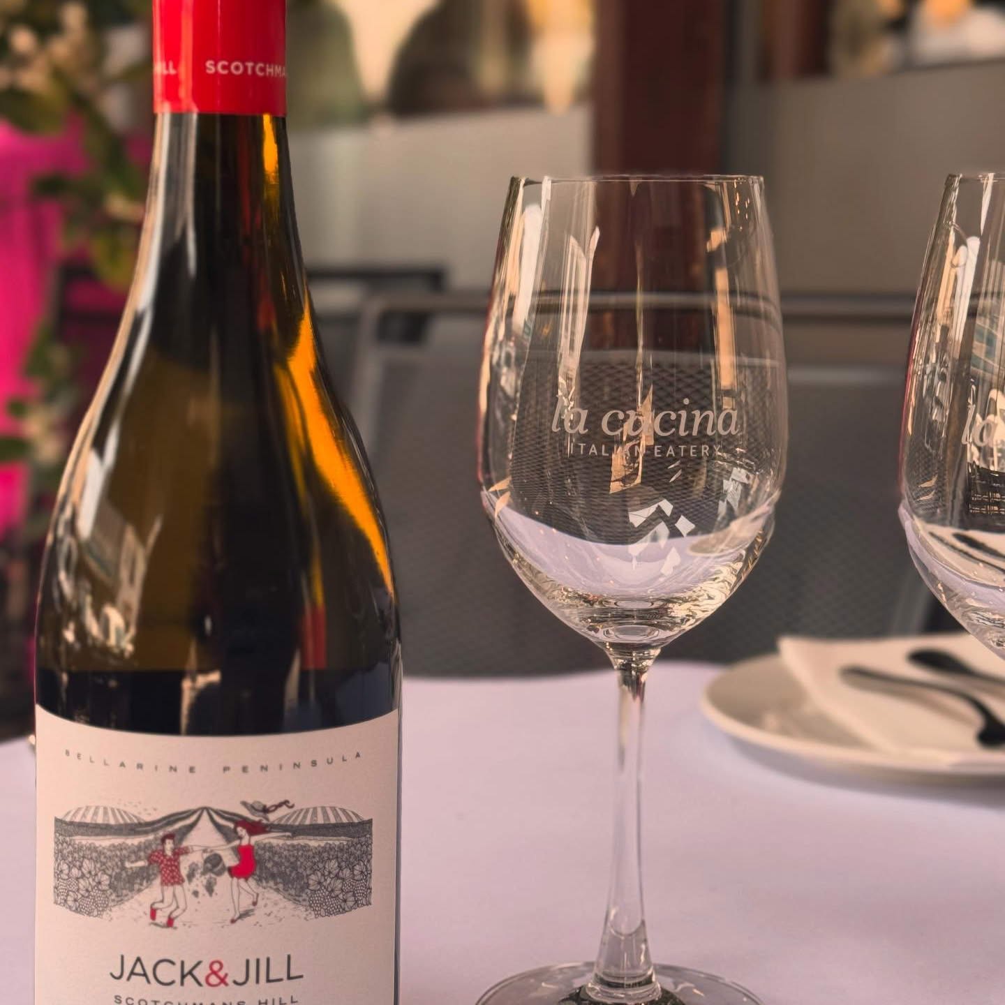 A La Cucina wine glass beside a bottle of Mornington Peninsula wine